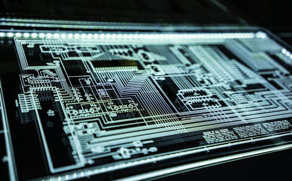 Close-up of a glowing teal circuit panel